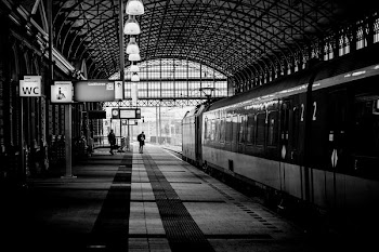 black and white photo of train on station