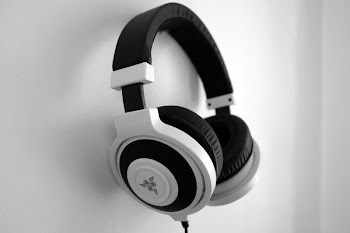 Black and White Razer Gaming Headset Hanging on White Painted Wall