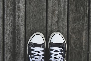 Black and White Sneakers on Grey Wooden Wood