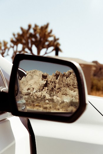 Black and White Wing Mirror Showing Brown Rocky Cliff