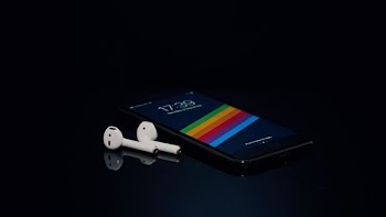 black Android smartphone and Apple AirPods