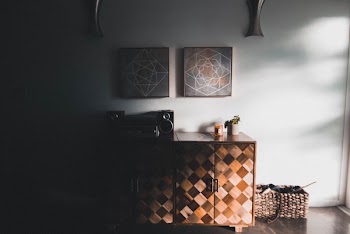 Black Audio Speaker on Brown Wooden Cabinet