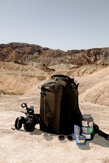 Black Backpack And Black Dslr Camera