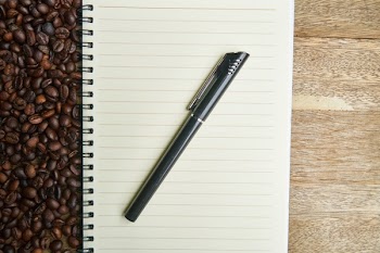 Black Ballpoint Pen on Notebook