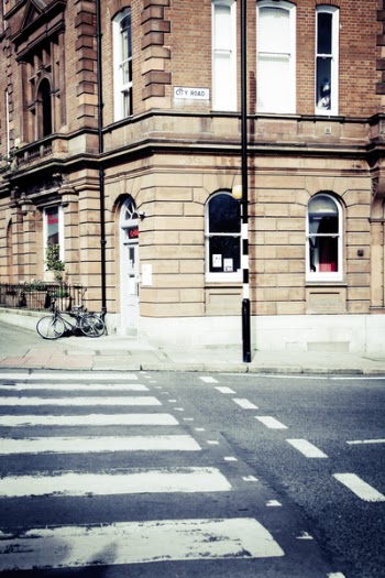Black Bicycle Parked on the Edge of a Street during Daytime