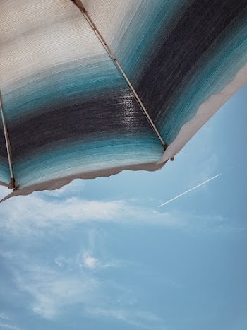 Black, Blue and White Umbrella Under Blue Sky