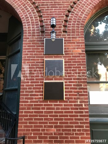 Black boards on a brick wall