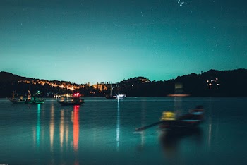 Black Boat on Body of Water