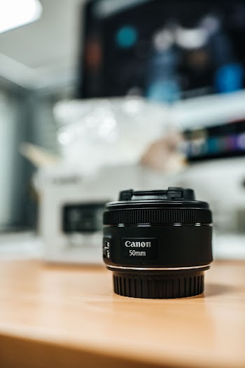 Black Canon 50mm Camera Lens On Table