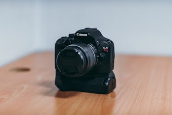 Black Canon EOS Camera Placed on a Table
