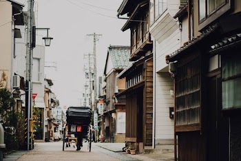 black carriage passing through buildings