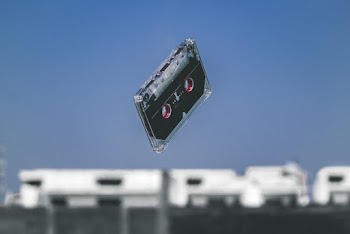 Black Cassette Tape in Mid-air