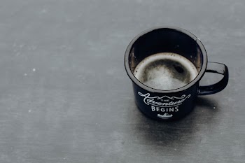 Black Ceramic Mug Filled With Coffee on Black Surface
