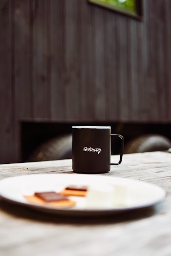 Black Ceramic Mug Near Round White Ceramic Plate