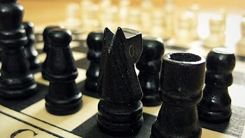 Black Chess Pieces on Chess Board