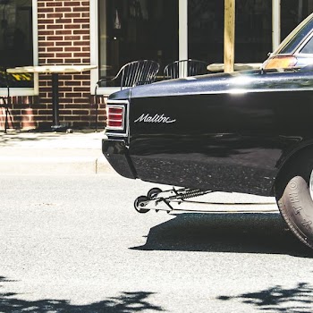 black Chevrolet Malibu on road at daytime