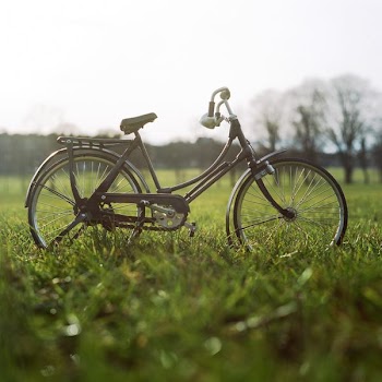 black city bike on green grass field