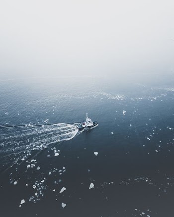 black coat on body of water