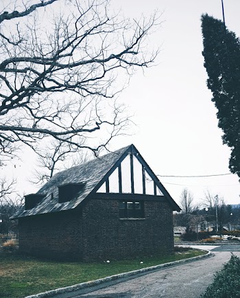 Black Concrete House Under Gray Clouds