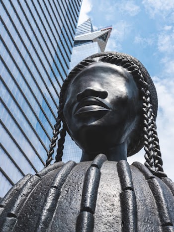 Black Concrete Human Statue Near Building during Day