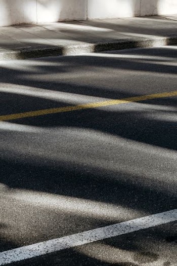 black concrete road with yellow and white paints