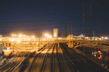 Black Concrete Roads Near Bridge at Night
