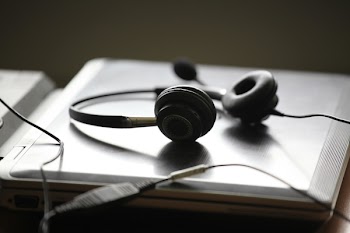 Black Corded Headset on Grey Laptop