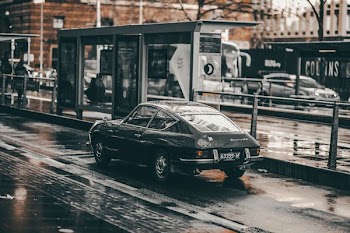 black coupe near rail at daytime