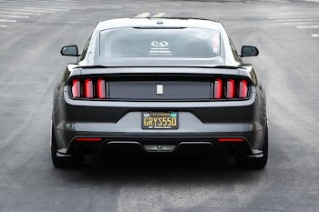 black coupe on grey concrete surface