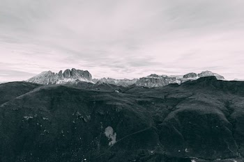 black covered mountain under white sky