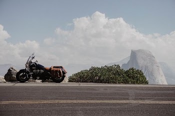 black cruiser motorcyle beside a black road
