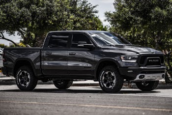 Black Dodge Ram 1500 Crew-cab Pickup Truck Parked Near Tree