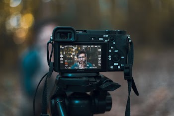 Black Dslr Camera Displaying Man in Blue Shirt