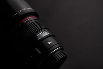 Black Dslr Camera Lens On Black Surface