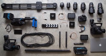 black DSLR camera near MacBook Pro