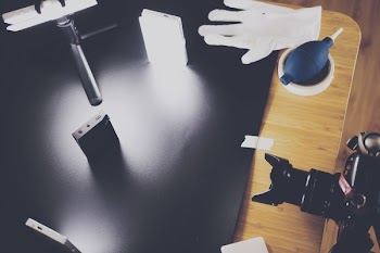 Black Dslr Camera on Top of Brown Wooden Table