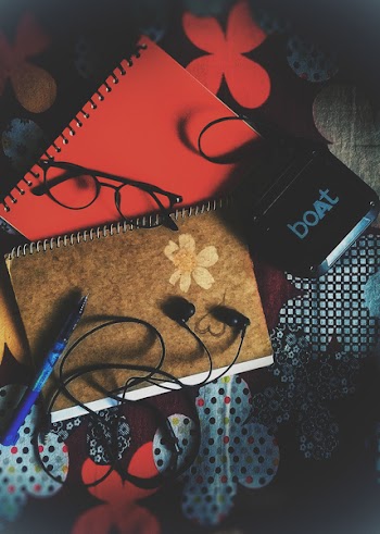Black Earbuds on Notebook