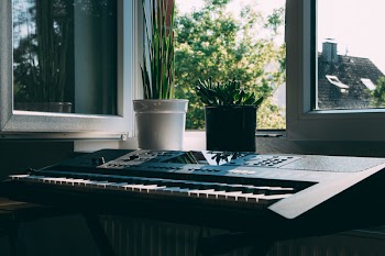 Black Electronic Keyboard Near Window