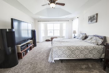 Black Flat Screen Tv on Foot of Bed