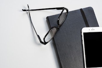 Black Framed Eyeglasses, Notebook and Smartphone