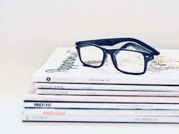 Black Framed Eyeglasses on Seven Collective Books