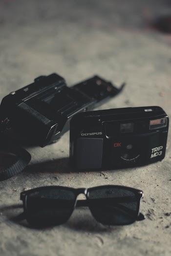 Black Framed Sunglasses And Cameras