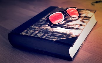 Black Framed Sunglasses on Black Book