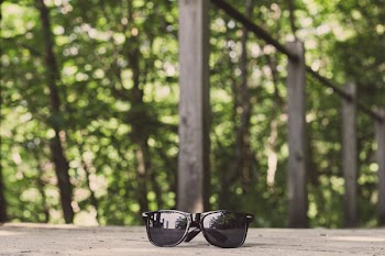 Black Framed Wayfarer-style Sunglasses on Floor