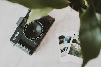 Black Franka Camera on White Textile