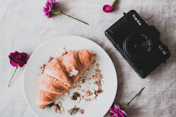 Black Franka Dslr Camera Beside Croissant