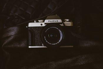 Black Fujifilm Point-and-shoot Camera on Black Textile