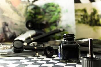 Black Glass Bottle on White and Black Checked Board