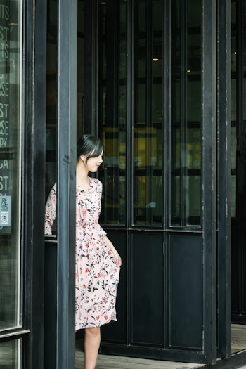 Black Haired Woman in Pink and Black Floral Dress