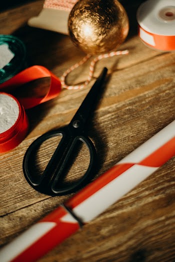 Black-handled Scissors on Brown Wooden Surface
